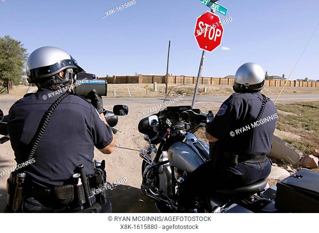 Police officers use radar to check the speed of motorists in Greely, Colorado, USA, October 3, 2011