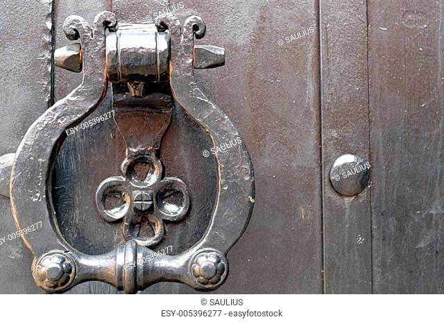 Vintage metal door handle. Ancient architecture