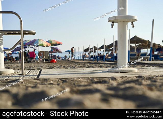 24 August 2023, Spain, Torrox: Showers to clean feet are laid dry on the beach in Torrox, a popular coastal community in the Axarquia region