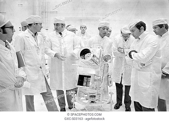 George Carruthers, center, principal investigator for the Lunar Surface Ultraviolet Camera, discusses the instrument with Apollo 16 Commander John Young, right