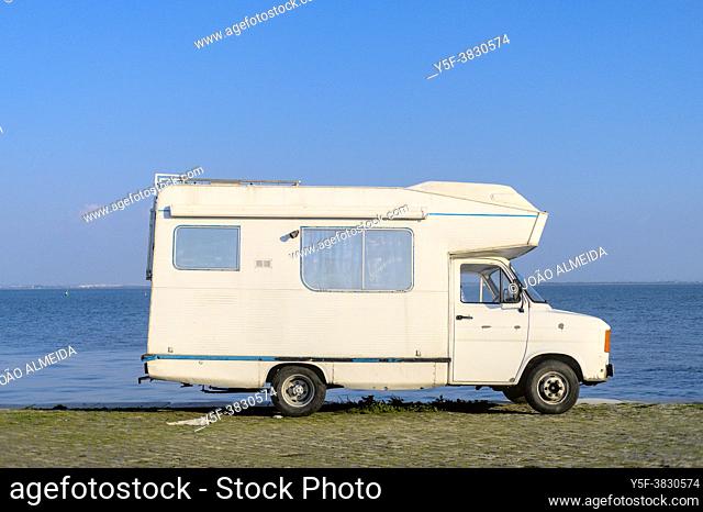 Vintage camper van parked by the riverfront
