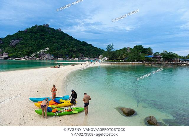 People with kayaks on Nang Yuan island beach, Ko Tao island, Thailand