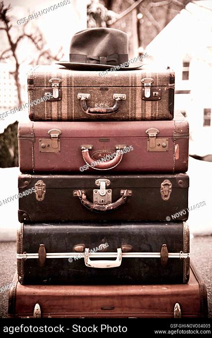 Stack of Vintage Suitcases with a Fedora Hat