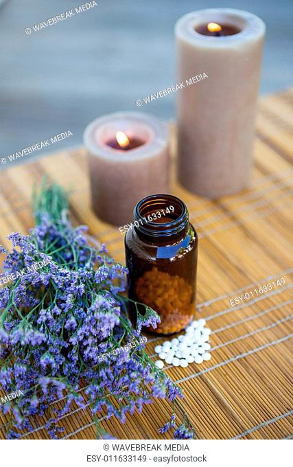 Bottle of pills above dried herbs