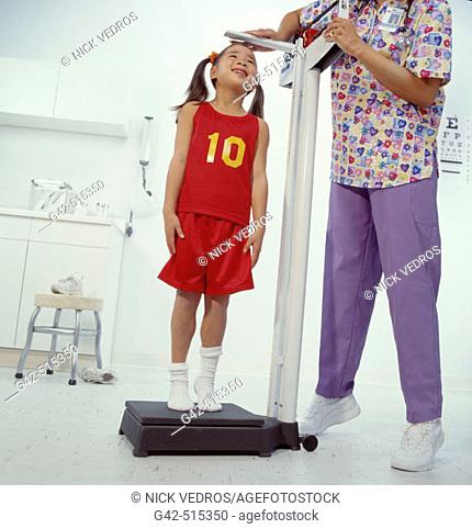 Young schoolgirl getting physical exam for playing school sports
