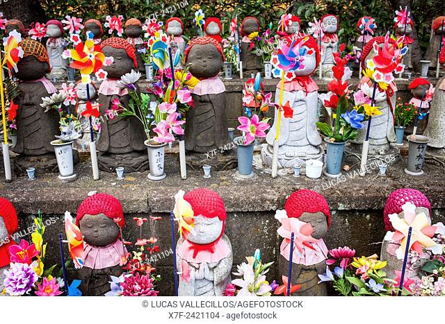 Statues of Jizo dedicated to dead unborn children, in Zojoji temple, Tokyo, Japan