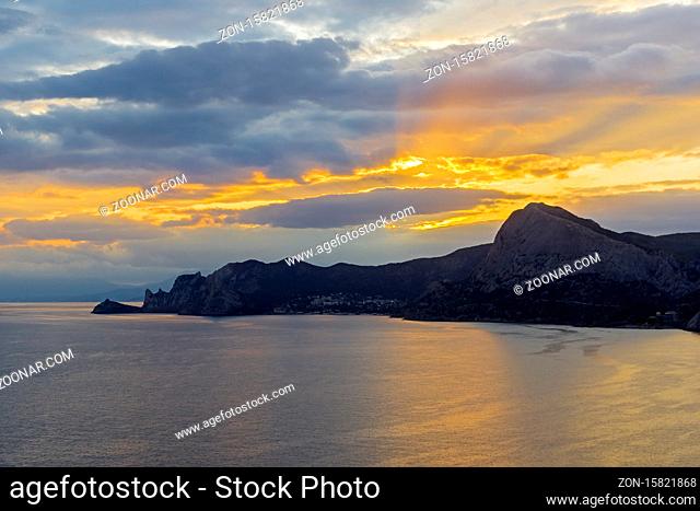 Sunset on the Black Sea coast of Crimea. View from the top of Cape Alchak to the west, towards Novyy Svet