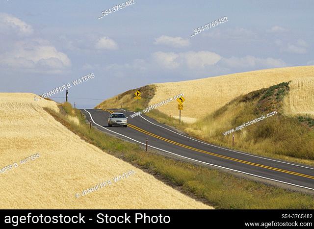 Car driving on a rural highway in the Palouse farming area of eastern Washington State, USA