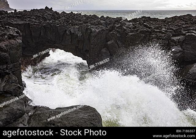 Lava arch on the volcanic coast at high tide with high waves, Ponta da Ferraria, Sao Miguel Island, Azores, Portugal, Europe