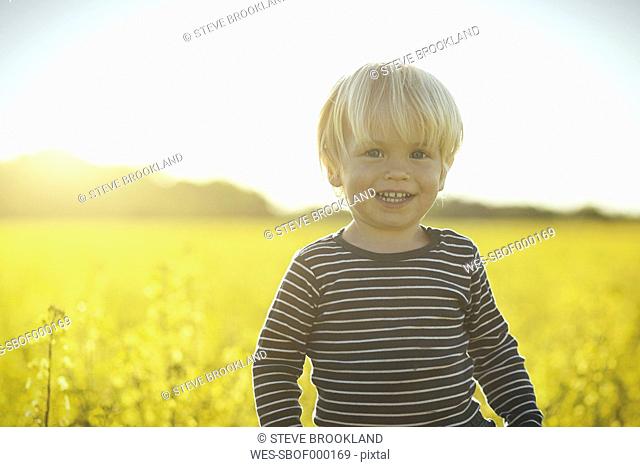 Portrait of smiling boy in canola field