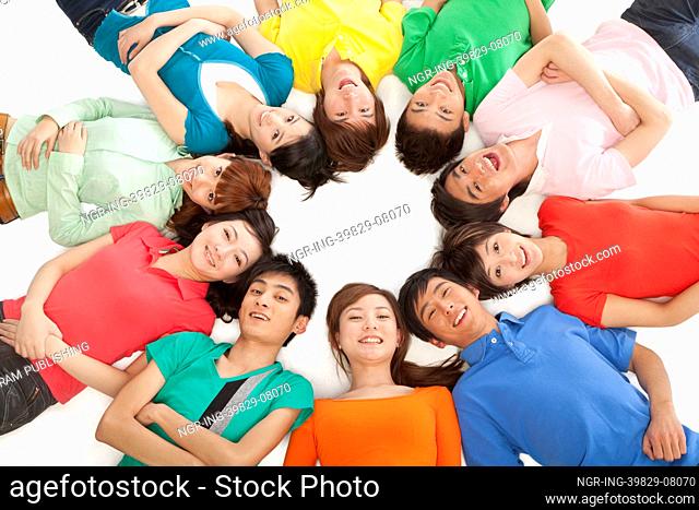 Young people lying in a circle