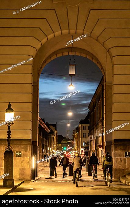 Copenhagen, Denmark People pass an old arched passageway at the Christiansborg Palace, site of government and Parliament