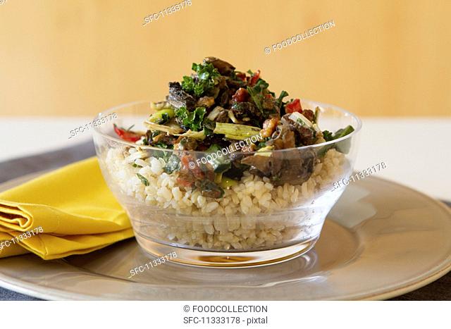 Rice salad with Portobello mushrooms, roasted peppers, dried tomatoes, kale and walnuts