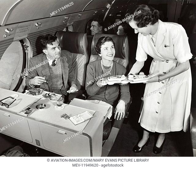 A Stewardess in a Bea Viscount Serving In-Flight Meals to Passengers in the First-Class Cabin