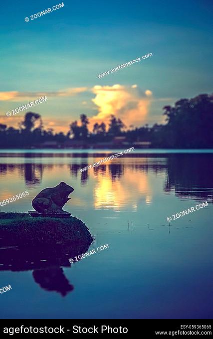 Frog sculpture on a shore of a lake near temple Pura Ulun Danu Bratanin, Bali, Indonesia