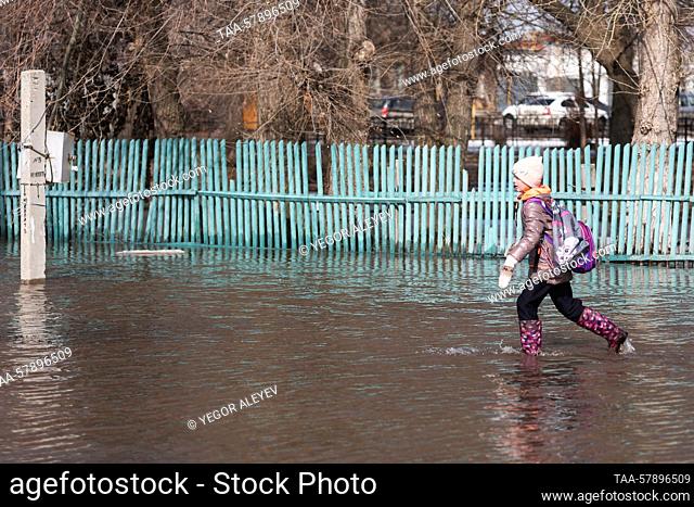 RUSSIA, SAMARA REGION - MARCH 16, 2023: A girl walks in a flooded street in the village of Chernorechye. First spring floods have been registered in several...