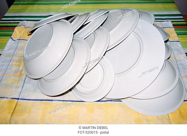 Clean dishes stacked on a dish towel