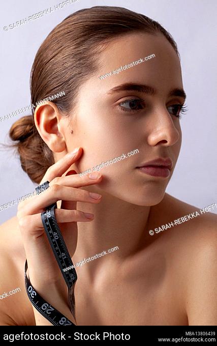 Woman with measuring tape, symbol beauty, pure skin, cosmetic surgery, be perfect