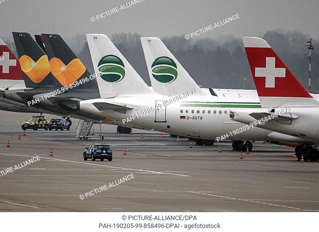 05 February 2019, North Rhine-Westphalia, Düsseldorf: Aircrafts of the airline Germania (2nd and 3rd from right) are standing on the apron at the airport in...
