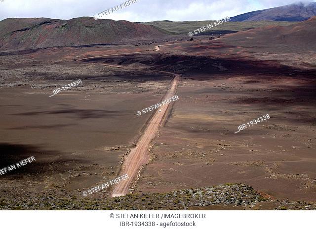 Dirt road on the Plaine des Sables plateau at the foot of the Piton de la Fournaise volcano, La Reunion island, Indian Ocean