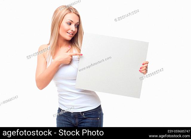 Beautiful happy young woman holding black poster. Isolated on white background. Copy space