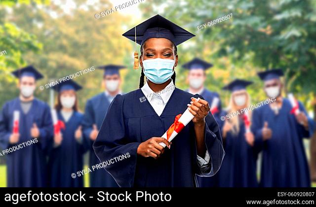 female graduate student in mask with diploma