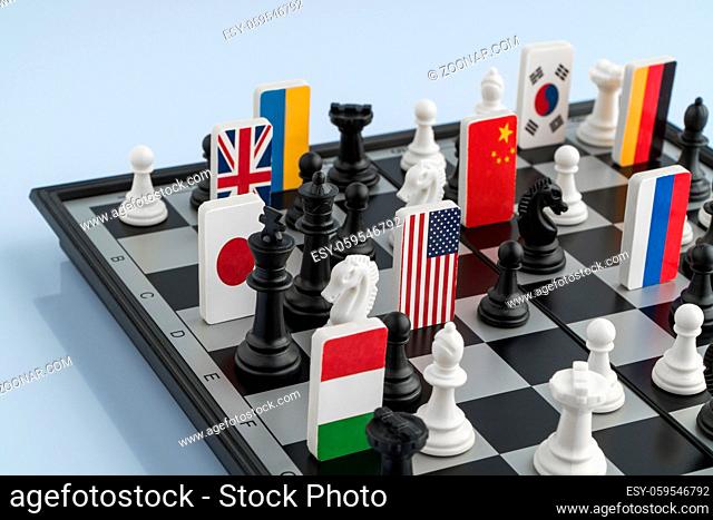 Symbols of the flags of the world on the chessboard. The concept of political game