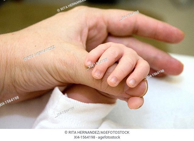 Close-up of Mommy and newborn hands