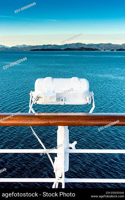 White metal marine exterior light fixture on railing of cruise ship, early morning, Alaska Inside Passage route