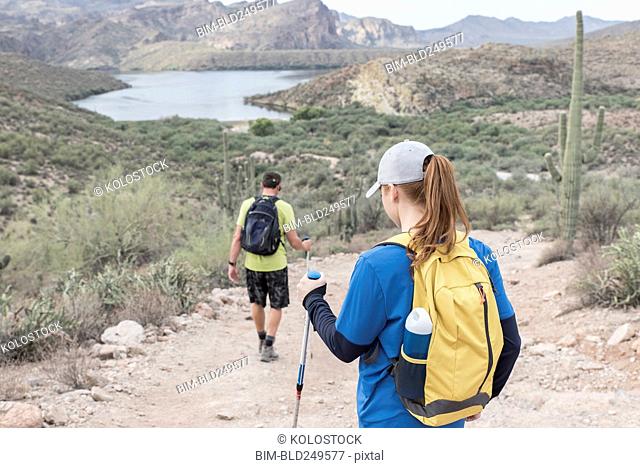 Couple hiking on rocky path in desert