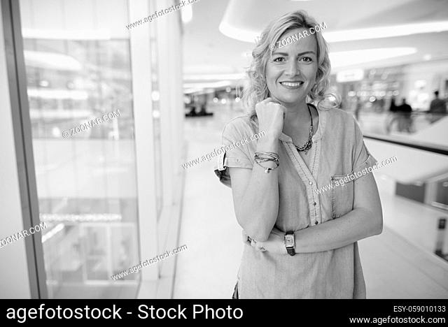 Portrait of beautiful blonde tourist woman exploring around the city in black and white