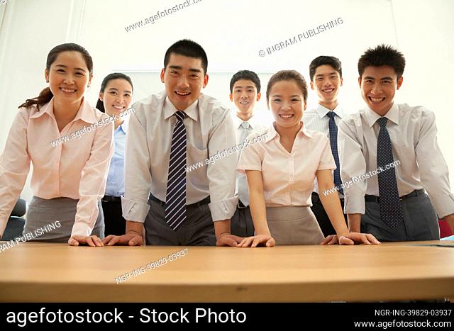Office team standing near the desk, portrait