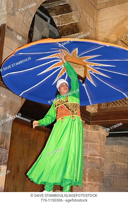 whirling dervish Sufi dancer in motion at performace in Cairo Egypt