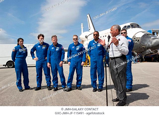 NASA Administrator Charlie Bolden introduces the STS-133 crew to media representatives waiting on the Shuttle Landing Facility at Kennedy Space Center in...