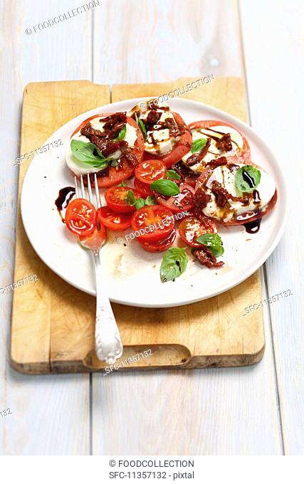 Iinsalata caprese - mozzarella, tomatoes, dried tomatoes and balsamic sauce