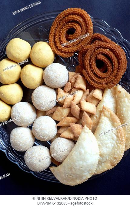 Besan Ladoo ; Rava Ladoo ; Karanji ; Shankarpali and Bhajani Chakli ; Homemade Maharashtrian Food made for Diwali Deepavali festival ; Mumbai Bombay ;...