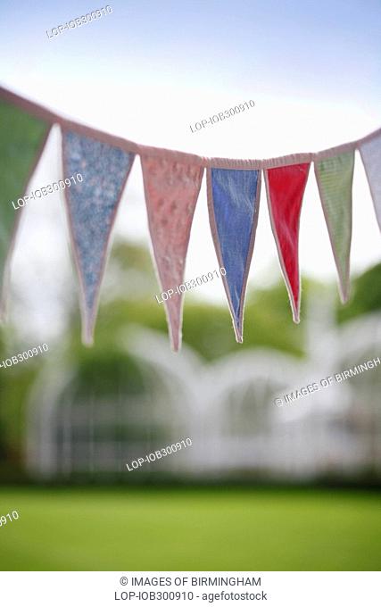 England, West Midlands, Edgbaston, Bunting hanging above a picnic in The Birmingham Botanical Gardens & Glasshouses