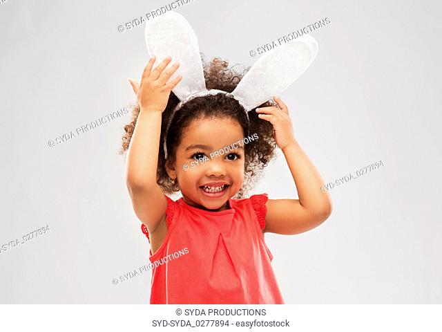 happy little girl wearing easter bunny ears