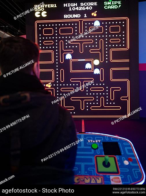 08 December 2022, Berlin: A young man plays the game ""Pacman"" on a slot machine in the arcade ""Gamestate"" at Potsdamer Platz