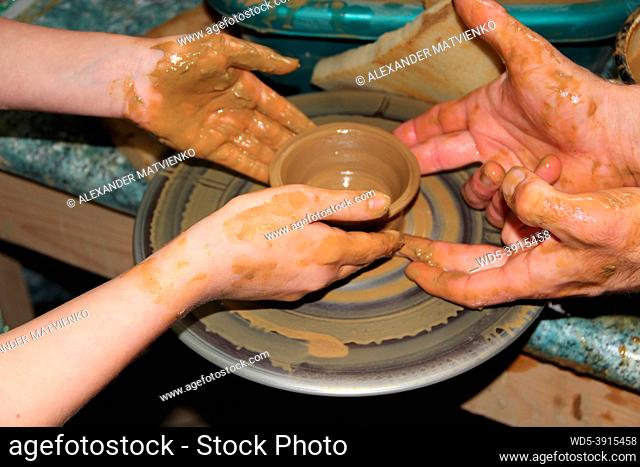 Pottery making process. Ceramic from clay. Art of pottery. Master class from clay on potter's wheel. Hands of potters creating earthen jar on the circle