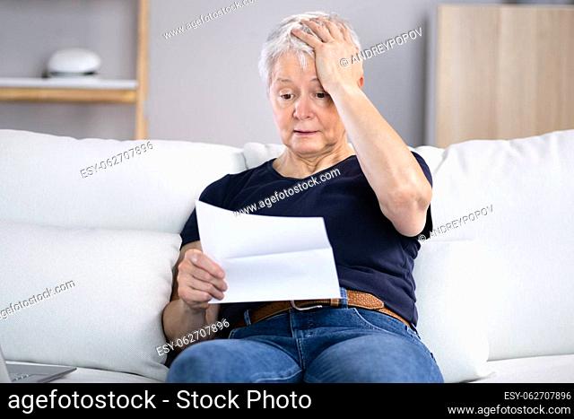 Portrait Of A Sad Young Woman Reading Documents