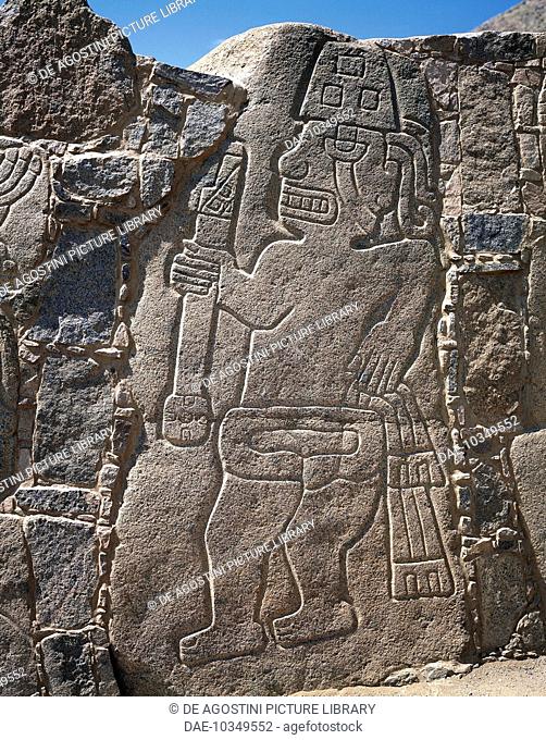 Stone stele with relief depicting a warrior with helmet and bat, Cerro Sechin, Ancash region, Peru. Sechin Culture