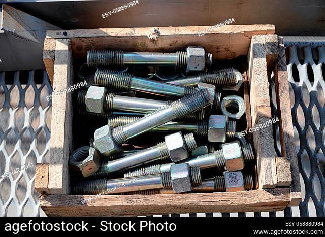 Metal studs for fixing process equipment at the refinery are in a wooden box