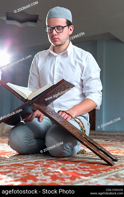 a muslim man is reading quran