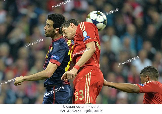Munich's Mario Gomez (R) and Barcelona's Sergio Busquets fight for the ball during the UEFA Champions League semi final first leg soccer match between FC Bayern...