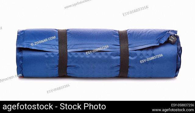 Front view of rolled blue self-inflating foam camping mattress isolated on white