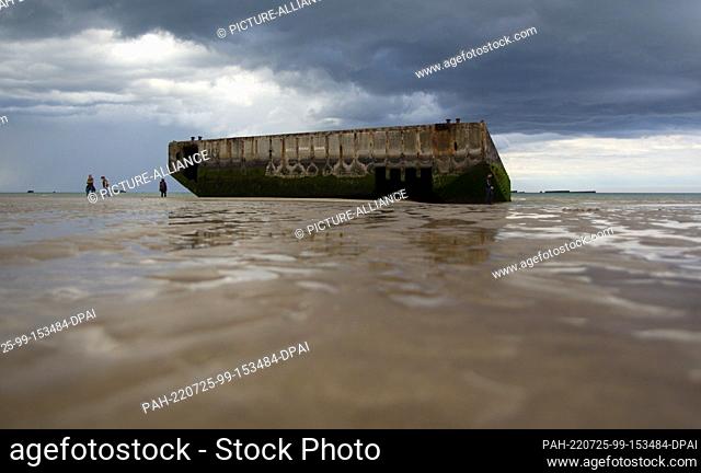 05 June 2022, France, Arromanches-les-Bains: Remains of the port facility ""Mulberry B"" lie on the beach. The artificial harbor was built during Operation...