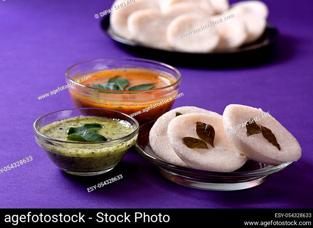 Idli with Sambar and coconut chutney on violet background, Indian Dish : south Indian favourite food rava idli or semolina idly or rava idly