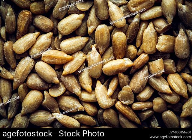 Peeled sunflower seeds macro background texture. Top view