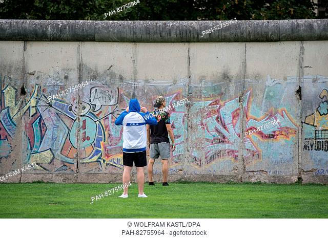 Tourists photographing leftovers of the Berlin wall at the memorial site Berliner Mauer in Berlin, Germany, 10 August 2016
